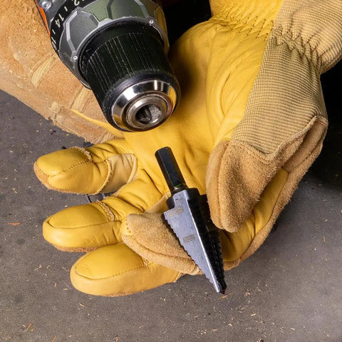 Person holding Step Drill Bit With Aluminum Titanium Nitride Coating For Long Lasting Durability next to a drill.
