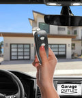 Person using Marantec M3 2312 315 MHz Two Button Remote With Programming Pin for garage door in car