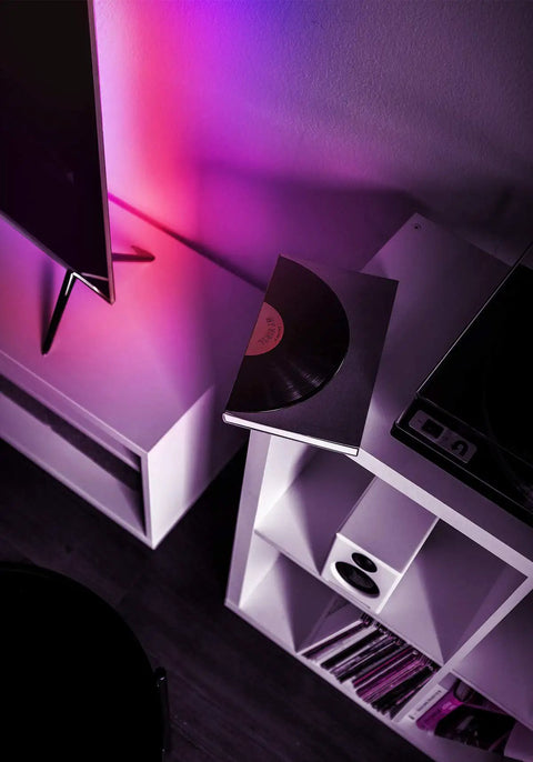 Z TV LED Light Strip Multicolor Kit With Wi Fi Control No Hub Needed casting vibrant colors behind TV and shelf.