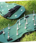 Green adjustable lawn aerator shoes straps, spiked sandals for soil aeration, garden care tool on grass surface