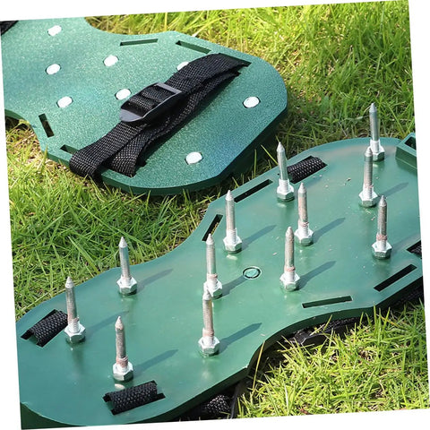 Green adjustable lawn aerator shoes straps, spiked sandals for soil aeration, garden care tool on grass surface