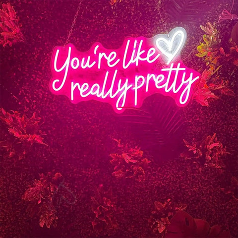 Lit Pink Neon Sign You're Like Really Pretty Wall Decor LED Light Up Sign against floral background
