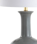 Close-up of gray ceramic base with brass neck of 27 Inch Gray And Brass Ceramic Table Lamp For Living Room And Bedroom With White Linen Drum Shade Modern Transitional Nightstand Lamp LED Bulb Included Energy Efficient And ETL Listed.