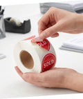 Red Round Self Adhesive Sold Stickers Two Inch Paper Labels For Retail Store And Warehouse Inventory Control Pricing Supplies 500 Pack With Strong Adhesion And Uniform Appearance For Clear Tagging And Easy Price Updates. hands peeling red sold paper labels roll