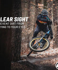 Mountain biker wearing protective gear on trail, featuring Front Big Bike Fender For Face Protection And Fork Shield Keeps You Clean And Dry On Enduro Trail All Mountain Cross Country Freeride Downhill And E Bike Rides Award Winning German Design.