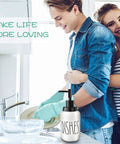 Couple washing dishes with Farmhouse Ceramic Soap Dispenser With White Glaze, Bold Black Pump And Lettering, 14oz on counter