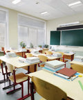 Classroom with desks and chairs, illuminated by Boss 2x2 LED Troffer Light With Stack Switch Drop In Ceiling Fixture For Dropped Ceilings Adjustable Lumens 3000 4000 5000 And Switchable Color Temperature 3500K 4000K 5000K White.