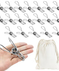 Built Like A Tank Heavy Duty Stainless Steel Clothes Pins 20 Pack in hand with canvas storage bag for laundry.