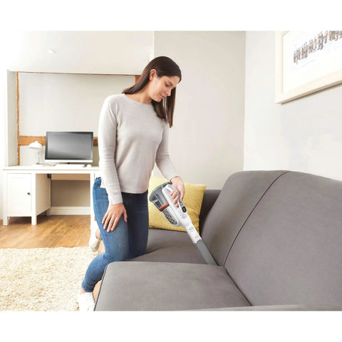 Woman using Handheld Cordless Car Vacuum Portable With Extended Runtime And Powerful Suction on a sofa