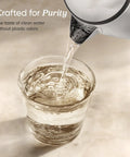 Plastic Free Interior Electric Kettle With 304 Stainless Steel pouring water into glass
