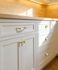 10 Pack 5 Inch Brushed Gold Cabinet Pulls Heavy Duty Solid Zinc Alloy Handles For Cabinets Dressers Kitchens And Bathrooms Easy Install Durable Furniture Pulls installed on white cabinets