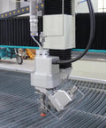 Rock Solid 5 Axis Cnc Water Jet Cutter Built Like A Tank Delivering Laser Precision Heavy Duty Grind For Metal Stone Glass And Concrete Shop Fabrication Projects close-up of cutting head