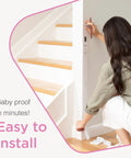Woman installing Retractable Baby Gate for Stairs and Doorways, 33 Inch Tall by 55 Inch Wide, Mesh Safety Gate for Kids and Pets, Gray