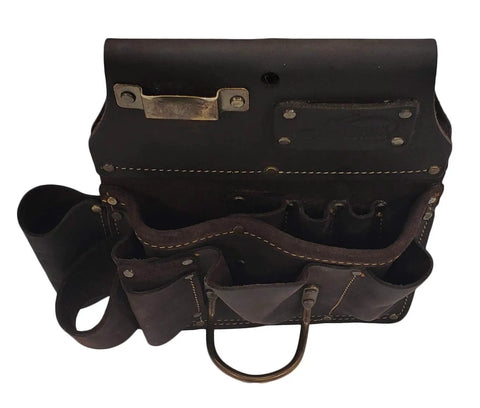 Top view of oil tanned leather drywall tool pouch with hammer loop and 12 pockets, showing heavy duty double stitching.