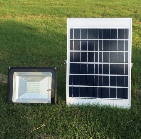 JUDYSSY Home Floodlight with a solar panel and LED spotlight on grass, 50W outdoor waterproof design.