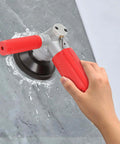 4-inch pneumatic wet-stone polisher/air sander with red textured grip used on a wet surface