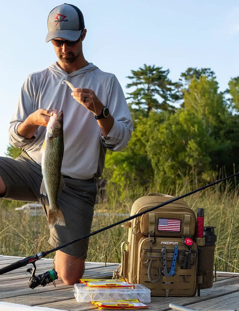 Angler on dock with fish beside All In One Fishing Backpack Tackle Bag With Two Rod Holders Ready To Roll in khaki