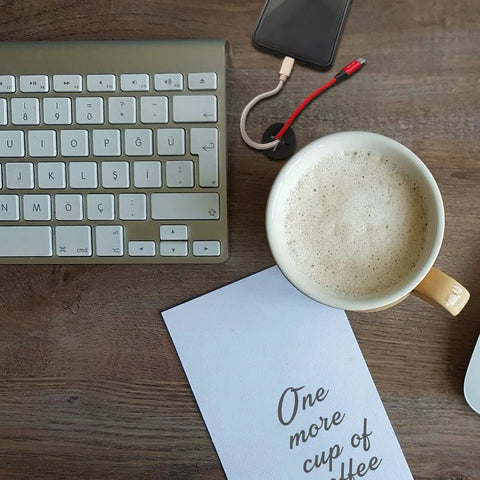 Office desk with keyboard, coffee mug, smartphone, and note. No visible 10 Pack Desk Grommets Three Quarter Inch 24mm Silicone Rubber Grommets.