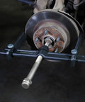 Powerful Brake Drum Puller And Rotor Removal Tool attached to a brake rotor, with three adaptors for hub removal using an impact wrench.