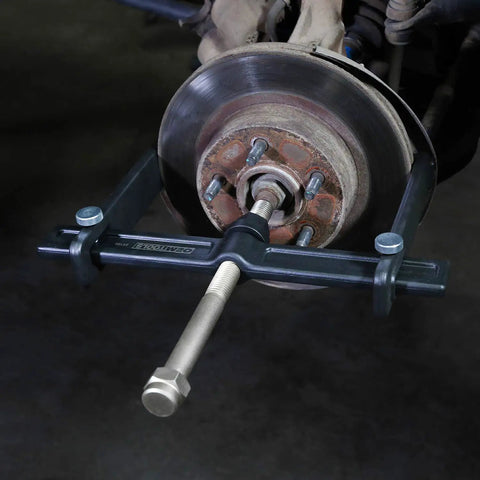 Powerful Brake Drum Puller And Rotor Removal Tool attached to a brake rotor, with three adaptors for hub removal using an impact wrench.