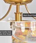 Close-up of modern industrial gold semi flush mount ceiling light with clear glass schoolhouse bowl shade and warm brass finish