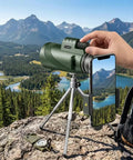 HD Monocular Telescope With 42mm Objective Lens on tripod with smartphone adapter, overlooking mountainous landscape for bird watching.