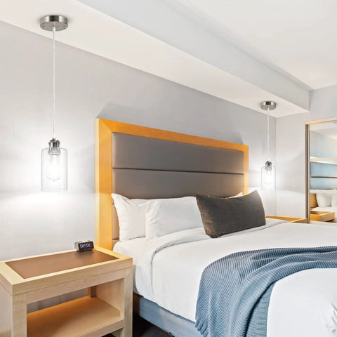 Three Pack Industrial Pendant Lights For Kitchen Island And Living Areas in bedroom with clear glass shades, over bedside tables.