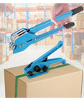 Heavy Duty Strapping Machine With 1000N Tension And 400Kg Break Strength, blue cast aluminum tool on a cardboard box.