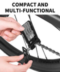 Hands using 20 In 1 Bike Multitool Kit For Cyclists Portable Foldable Cycling Tool With Allen Wrenches Tire Levers Chain Breaker on bike chain