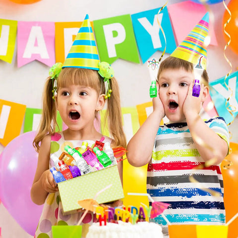 Kids at a party holding Science Theme LED Finger Lights 32 Pack with rainbow decor in the background.