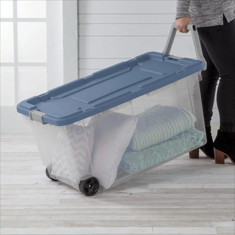 Slick Rolling 2 Pack 160 Quart Heavy Duty Storage Totes With Oversized Swivel Casters And Lockdown Pull Handle Extra Large Wheeled Plastic Bins Drip Resistant Double Latch Systems Garage Ready, showing a wheeled bin with bedding.