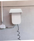 Heavy Duty Outdoor EV Charger Enclosure Weatherproof Rain Shell For Your Electric Vehicle Plug With Rock Solid UV Guard and Super Quick Install Housing Box For Built Tough Longevity mounted on wall with charging cable.