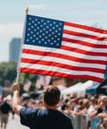 Person holding 3x5 Ft Heavy Duty Outdoor American Flag Deluxe Spun Polyester Waterproof UV Resistant Embroidered Stars in a parade.