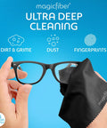 Front view: MagicFiber glasses cleaning kit with two spray bottles and two black microfiber cloths, wiping eyeglasses.