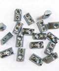 Heavy Duty Forty Pack Steel Spring Ball Roll In T Slot Nuts with Quarter Inch Twenty Thread from above on white surface.