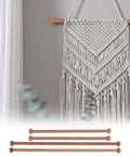 Set Of Four Top Shelf Wooden Dowel Closet Hangers With Burr Free Smooth Sandalwood Finish 12 Inch And 9 Inch Rods For Wardrobe Storage Durable Classic Design Garment Sticks displayed against a wall with macrame decor.
