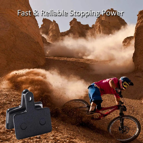 Ride Ready Disc Brake Pads For Shimano Mountain Bikes M315 M355 M515 M525 C501 C601 M375 M395 M415 M416 M446 M465 M475 M485 M486 Semi Metallic Resin Replacement Pads 2 Pairs For Reliable Stopping Power with a biker riding downhill.