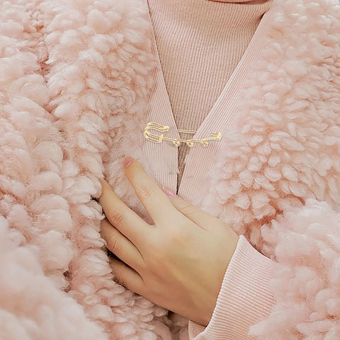 Premium 20 Pack Of Versatile Loop Safety Pin Brooches To Clasp Sweaters Scarves And Denim Belts While Adding Instant Chic Vibes To Everyday Streetwear And Casual Fits worn on pink fluffy sweater.