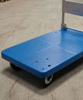 Heavy Duty Folding Transport Cart With Aluminum Handle And Rugged Deck For Easy Box Hauls In Warehouses Labs And Classrooms Four Wheel Push Cart For Daily Use And Reliable Smooth Mobility, blue deck angled view