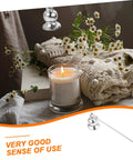 Christmas Metal Candle Fire Extinguisher Cap With Long Handle above a lit candle and cozy sweater with flowers.