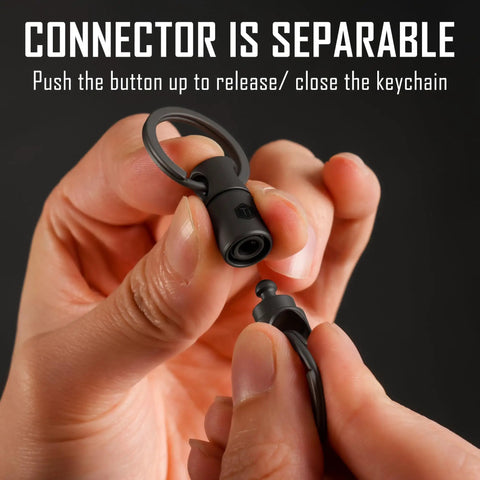 Hands holding Titanium Detachable Key Ring Connector With Double End Swivel, showcasing quick-release feature, black KA24BK1 Pack.