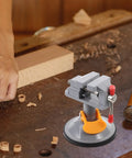 Mini Vise Clamp With Suction Mount Fully Rotatable Bench Vise in use on a woodworking table securing a workpiece