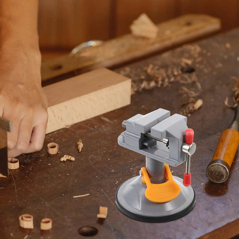 Mini Vise Clamp With Suction Mount Fully Rotatable Bench Vise in use on a woodworking table securing a workpiece