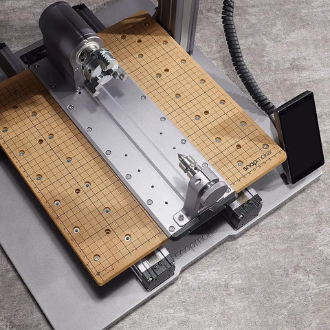 Next Level Rotary Module For Your Desktop Maker Machine Featuring Sweet 4 Axis Cnc Carving And Laser Engraving With Hella Precise Strain Wave Gearing And A Solid 3 Jaw Chuck Designed To Upgrade Any A350 Style 3D Printer Setup Today on a work surface with grid pattern.