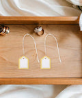 Fan Shaped Golden No Frills Price Tags With String 500 Pack Blank Writable Surface For Clothes Gifts Jewelry Crafts And Vendor Booth Displays Perfect For Marking Items At Sales., two gold-and-white tags on wood tray