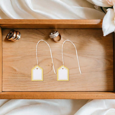 Fan Shaped Golden No Frills Price Tags With String 500 Pack Blank Writable Surface For Clothes Gifts Jewelry Crafts And Vendor Booth Displays Perfect For Marking Items At Sales., two gold-and-white tags on wood tray