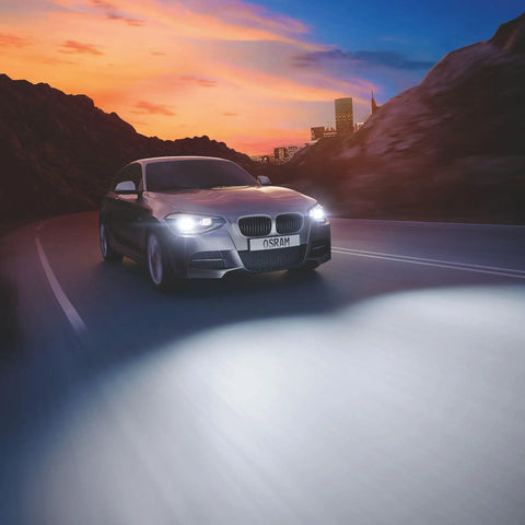 Car with Night Breaker Laser D1S HID Xenon Bulb Next Generation 200 Percent Brighter Up To 250 Meter Long Beam driving at sunset