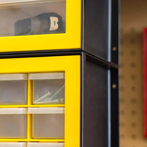 Close-up of Totally Rad Plastic Hardware Organizer With Forty Four Drawers showcasing screws in yellow wall-mount box.