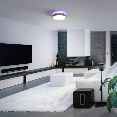 Modern living room with Motion Sensor LED Ceiling Light 14 Inch Dimmable 1600 Lumens Fixture With RGB Mood Lighting illuminated.