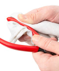 6 Inch 70 Degree Long Nose Pliers With Slim Bent Nose For Tight Obstructions, being wiped clean with a cloth in hand